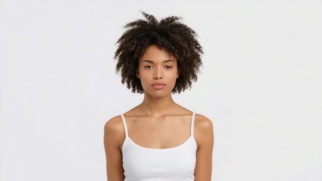 Serious woman making stop gesture in white top