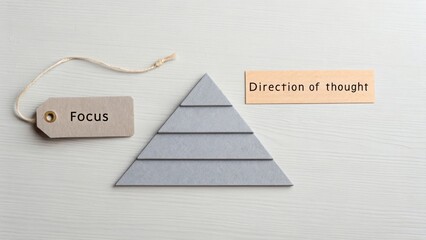 Minimal Design with Layered Grey Triangle on Tabletop