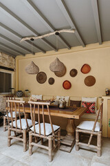 Charming Outdoor Dining Area with Rustic Rattan Chairs and Warm Lighting, Cozy Mediterranean Patio Vibes