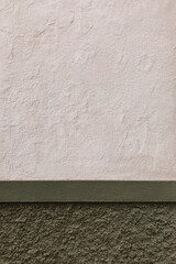Aged white wall with green base