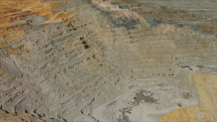 Aerial of open mine and heavy mining equipment