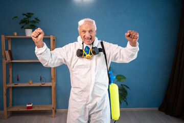portrait of Happy Elderly pest control worker celebrating victory winner success inside infested...