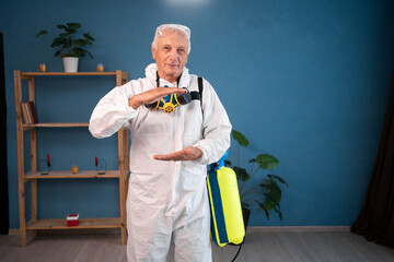 portrait of Elderly pest control worker showing big size object, shaping large box, inside infested...