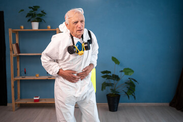 Elderly pest control worker suffering Stomach ache and abdominal pain inside infested house....