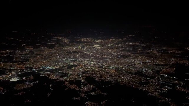 Paris, capital of France, aerial view during night time - brightly illuminated,  including central downtown part of the city with river "Seine",  illuminated buildings and streets - 4k aerial footage