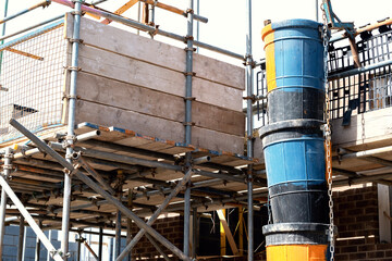 Scaffold platform installed around working area to provide safe platform and loading bay for bricklayers