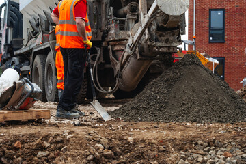 Mixer truck delivered concrete on construction site and unloaded on ground