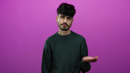 Young man with dark hair stands frustrated against an isolated pink background in this expressive portrait. © Krakenimages.com