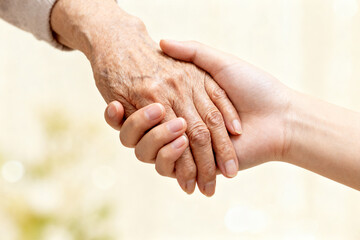 Hands of different ages holding each other