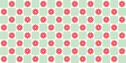 Red flower chessboard gingham pattern background. Floral seamless pattern with red daisy on green checkered squares. Perfect for spring design, fabric, wrapping, and decorative projects.