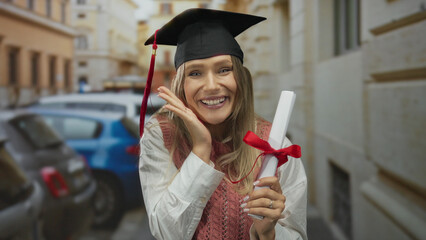 Young woman smiling on city street holding diploma wearing graduation cap symbolizing achievement...