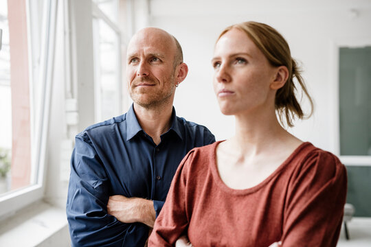 Business colleagues in a loft office looking ahead with confidence