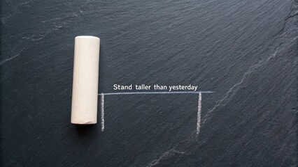 Inspirational chalk writing on slate surface encouraging personal growth and positive mindset transformation through daily improvement