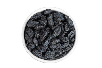 black raisins in ceramic bowl isolated on white background. Top view. Flat lay