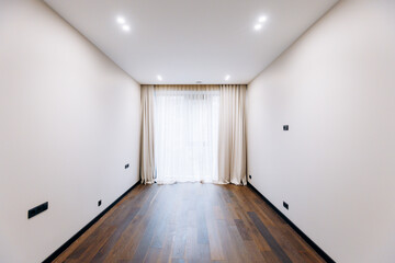 This is a bright and minimalist interior design of an empty room featuring a wooden floor
