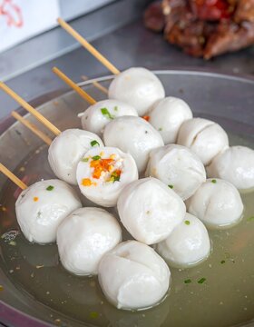 Skewered, spherical food in liquid