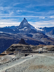 Scenic view from the top of Gornergrat with the arched railway line and the majestic Matterhorn mountain in the Swiss Alps. 