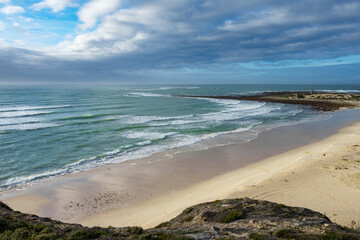 A scenic view from sea cliffs near Waenhuiskrans towards Struis Point and Saxon Reef, showcasing serene coastline, turquoise sea, Die Otter beach in Arniston, Western Cape, South Africa.