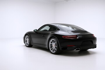 Naklejka premium Sleek Black Sports Car in a Studio Setting Showcasing Automotive Design and Performance Engineering