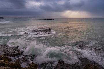 Marine view of Arniston’s stunning rocky coastline in Overberg, Western Cape, South Africa. Dramatic shore, textured rocks and tranquil sea create a scenic coastal landscape for travel and nature.