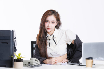 Asian pretty confident young woman in modern office attire smile sitting pose at desk with laptop telephone coffee cup printer, Professional business portrait in white studio fashion  style background