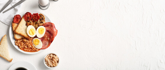 Plate of tasty English breakfast with boiled eggs on white background