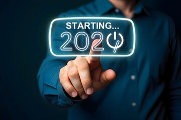 Obraz premium Person touching a neon starting year graphic with power icon on a dark blue background in studio shot