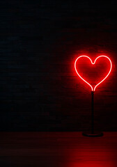 Neon red heart lamp on wooden table against dark background  