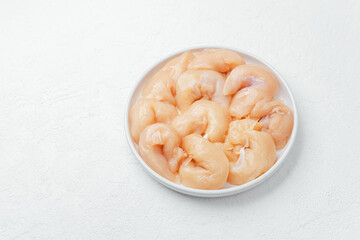 Fresh raw chicken breast fillet slices  with tomatoes salt and spices on black background