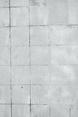 Old white tiles surface with dark lines showing wear and water stains creating texture