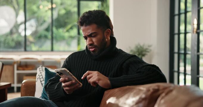 Frown, phone and scam with man on sofa in living room of home for social media or text message. Confused, doubt and typing with unhappy person in apartment for communication, mobile fraud or phishing