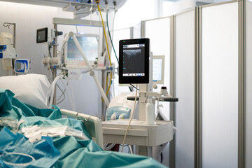 Icu patient bed with medical equipment and monitor