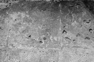 Black-and-white concrete erosion vignette for concept of decay and structural aging