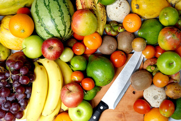 Exotic fruits mix with mango orange and pineapple. knife and cutting board.