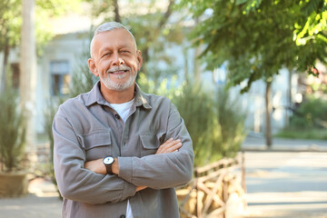Fototapeta premium Portrait of senior man on sunny day in park