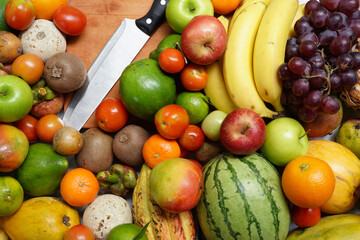 Fresh tropical fruits perfect for diet and detox. cutting board and knife.