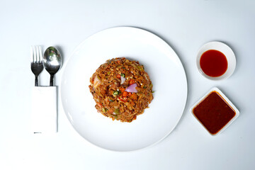 Tasty Spicy Kottu Roti with Vegetables on White Plate.