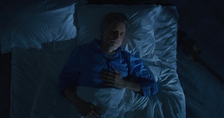Gray Haired Mature Man Lies in Bed Unable Sleep, Lost in Thoughts About Aging and Solitude. Concept...
