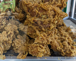 Piles of Kentucky fried chicken in the food display case, Crispy fried chicken
