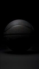 black basketball close up on dark background with detailed texture minimalist sports equipment product photography