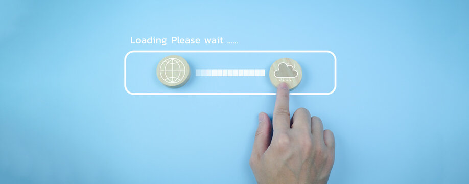 Cloud computing data upload concept showing a hand pressing virtual cloud icon on blue background with loading progress bar, representing online technology and digital transfer process.