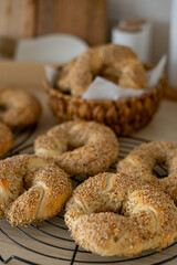Hot homemade Turkish simit in the kitchen. Bagels with sesame seeds. Pastries.