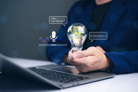 Businessman holding AI glowing light bulb over laptop symbolizing artificial intelligence assistant, chatbot innovation, and smart digital communication for modern business technology concept.