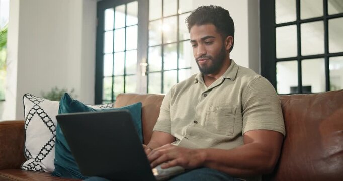 Man, couch and typing on laptop at house for research, proofreading article and copywriting. Male person, freelancer and pc for story submission, editor feedback and information for publication draft