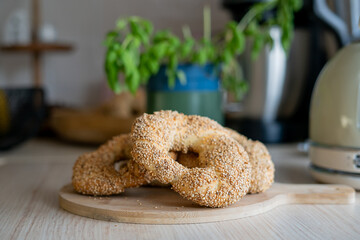 Hot homemade Turkish simit in the kitchen. Bagels with sesame seeds. Pastries.