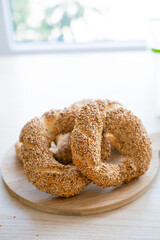 Hot homemade Turkish simit in the kitchen. Bagels with sesame seeds. Pastries.