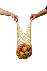 Obraz premium Two hands holding a mesh bag full of apples, symbolizing cooperation, eco-friendly living, and sustainable habits through reusable shopping and shared values