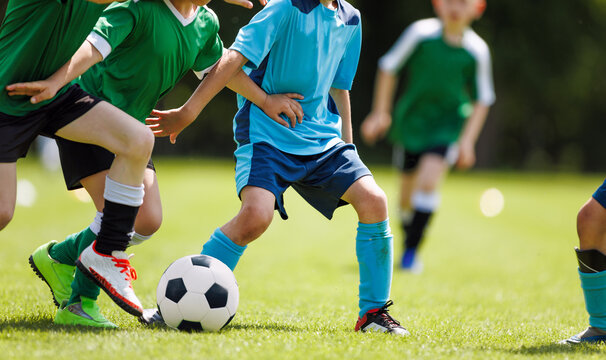 Children Playing Soccer Outdoors.  Youth Football Match and Training Game for Kids Sports Development