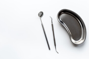 Dental equipment tools for teeth care on white background. Professional Dentist desktop, top view