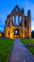 Illuminated abbey ruins at twilight